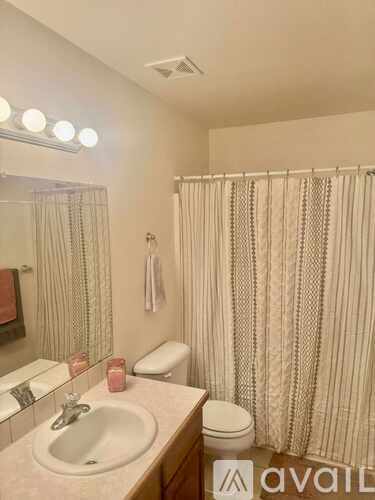 A room with a ceiling fan and a chandelier.