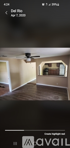 A room with a ceiling fan and a mirror on the wall.