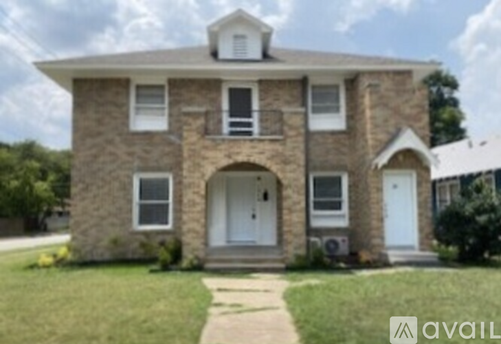 A house with a stone facade and a white door is for sale.