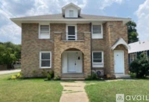 A house with a stone facade and a white door is for sale.