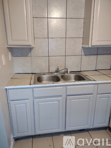 A kitchen with a sink and cabinets.