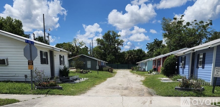 A row of mobile homes with a stop sign in front of the first one.