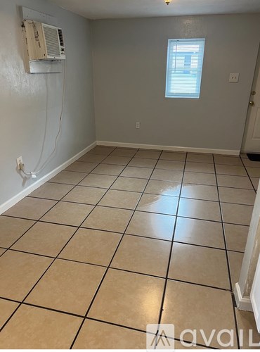 A room with a tile floor and a window.