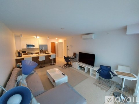 A living room with a grey couch and a blue chair.