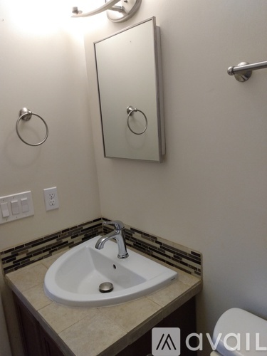 A bathroom with a sink and a mirror.