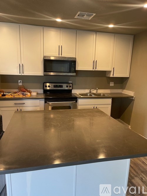 A kitchen with a stove, oven, and microwave.