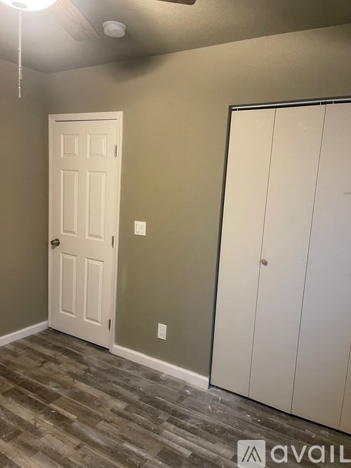 A room with a white door and a white cabinet.