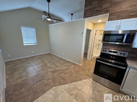 A kitchen area with a stove top oven and microwave.