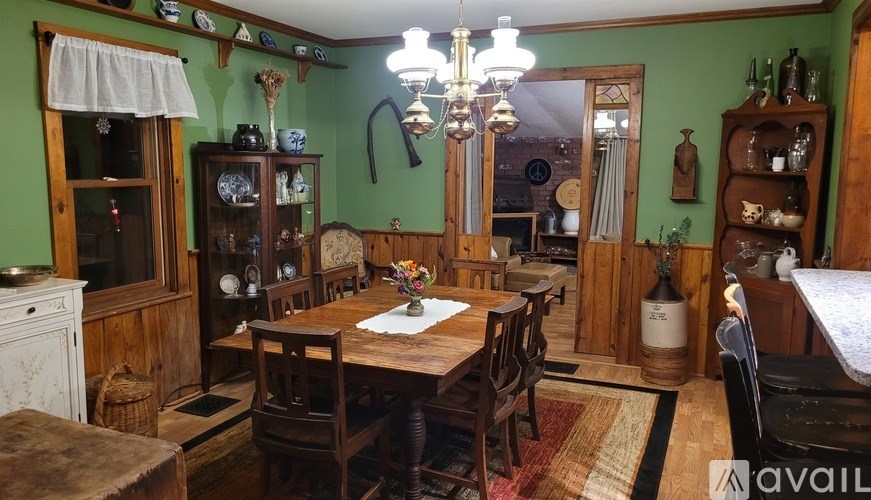 A dining room with a wooden table and chairs.