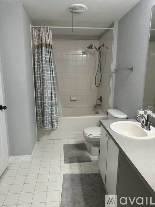 A bathroom with a toilet, sink, and shower.