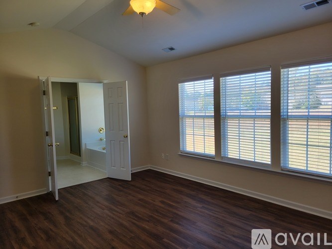 A room with a sliding door and a window with blinds.