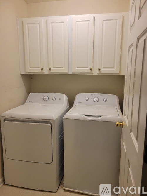 Two front loading washing machines in a laundry room.