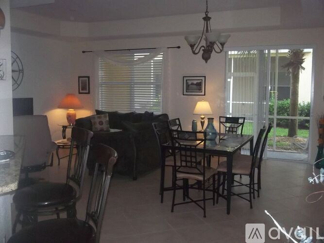 A dining room with a table set for six.
