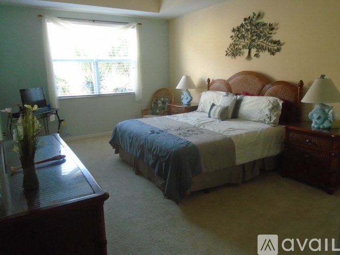 A bedroom with a large bed and a wooden headboard.