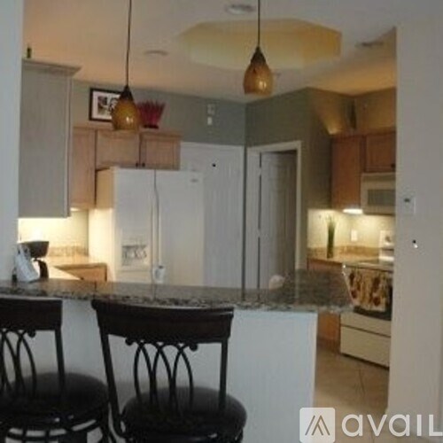 Two bar stools are in front of a kitchen island.