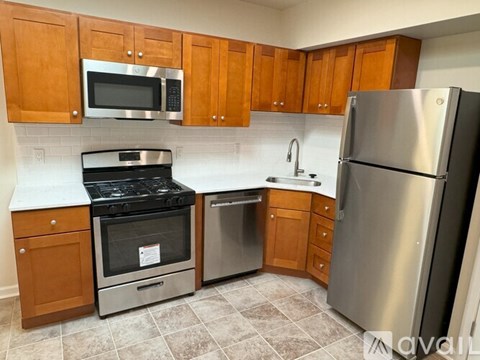 A kitchen with wooden cabinets and stainless steel appliances.