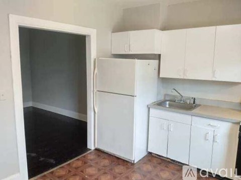 A kitchen with white cabinets and a sink.