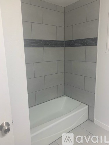 A white bathroom with a glass shower door.