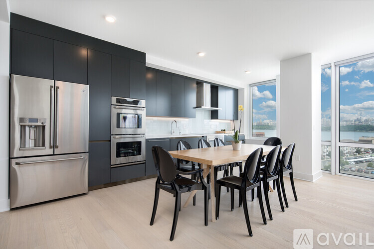 A modern kitchen with a dining table and chairs.