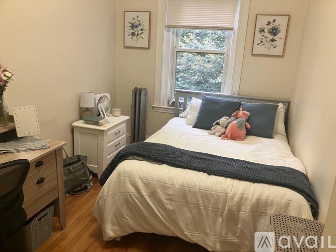 A bathroom with a sink, mirror, and shower.