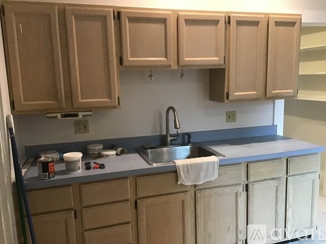 A kitchen with brown cabinets and a grey countertop.