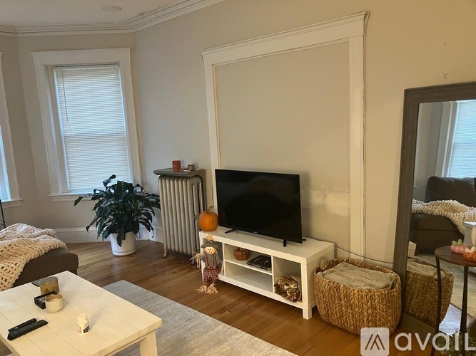 A room with a window and wooden floors.