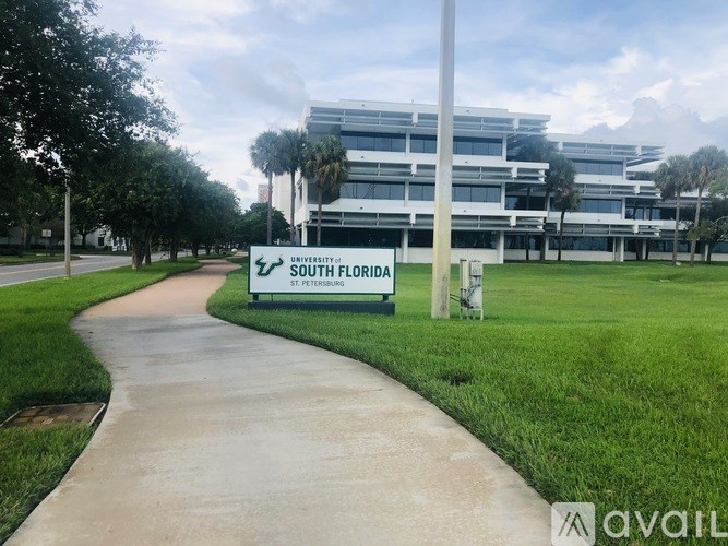 A pathway leads to a building with a sign that says South Florida.