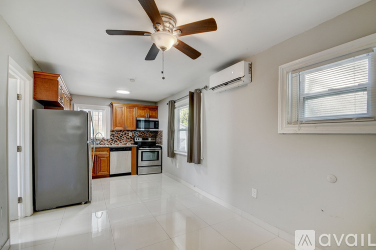 A kitchen with a refrigerator, microwave, and oven.