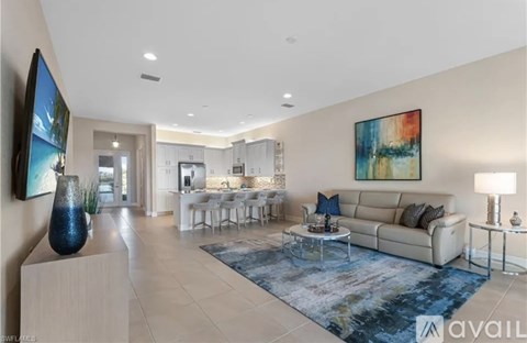 A modern living room with a large painting on the wall and a sofa with throw pillows.