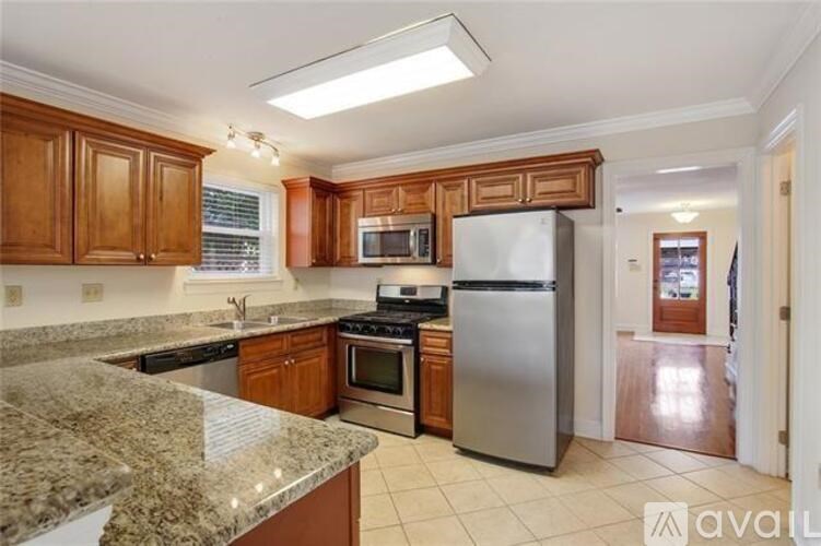 A kitchen with granite countertops and stainless steel appliances.