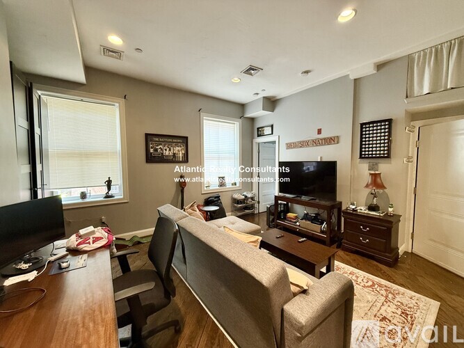 A kitchen with black cabinets and stainless steel appliances is on the market.