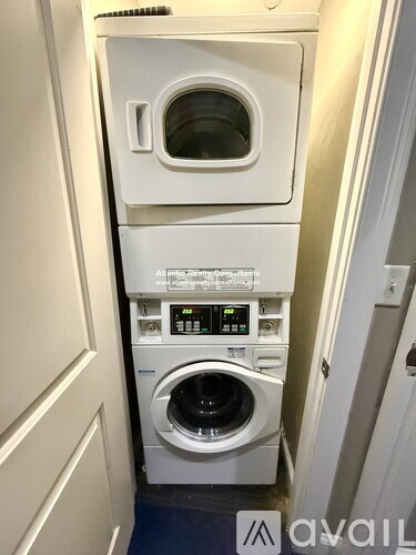 A washing machine and dryer stacked on top of each other in a small space.