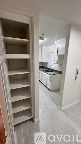 A kitchen with white cabinets and a white oven.