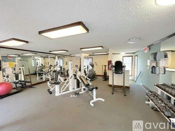A gym with a variety of equipment including weights and machines.