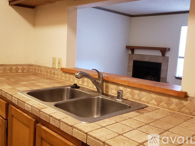 A kitchen with a sink and a fireplace.