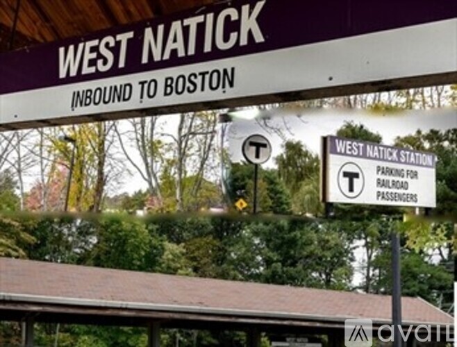 A sign for West Natick station with a train symbol on it.