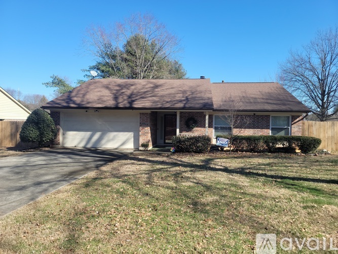 A house with a brown roof and a white garage door.