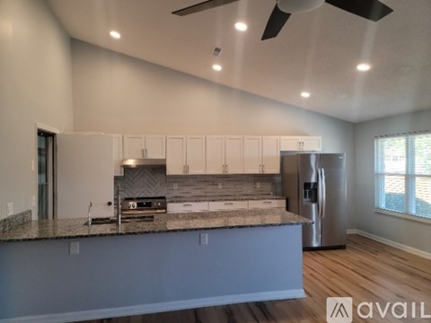 A modern kitchen with a large island and stainless steel appliances.