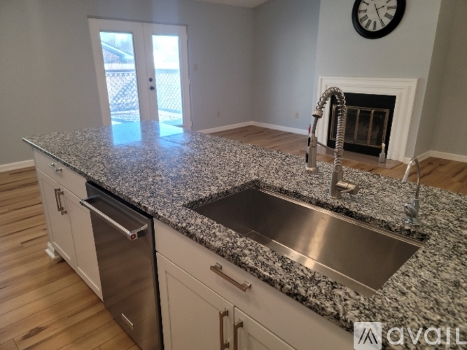 A kitchen with granite countertops and a stainless steel sink.