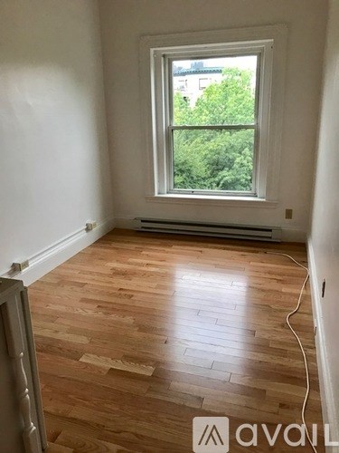 A room with wooden floors and a window.