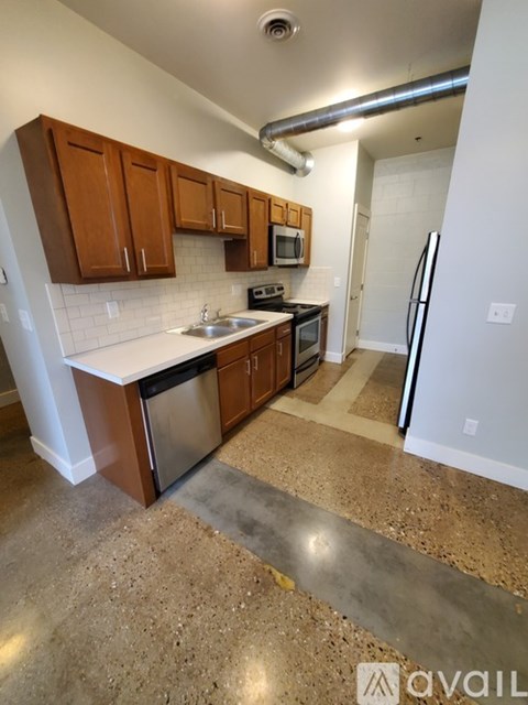A kitchen with brown cabinets and a white counter top.