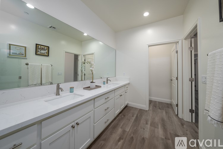 A bathroom with two sinks and a large mirror.