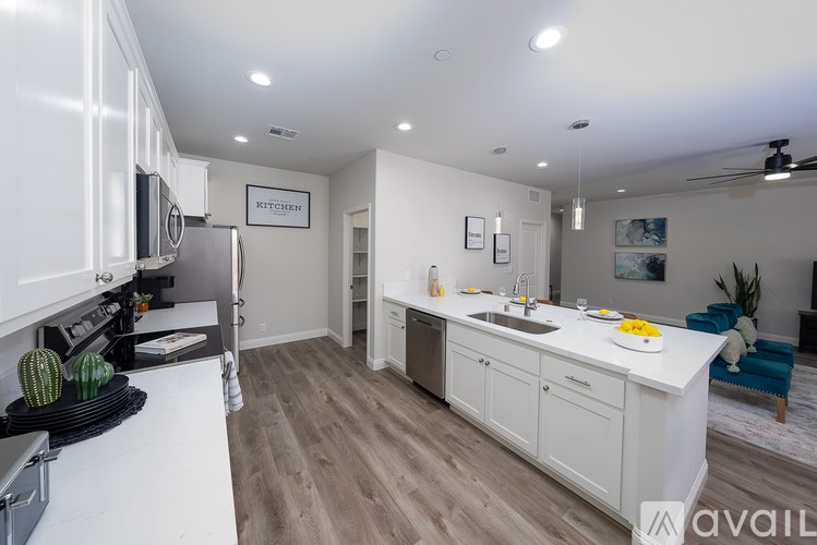 A kitchen with white cabinets and a white counter top.