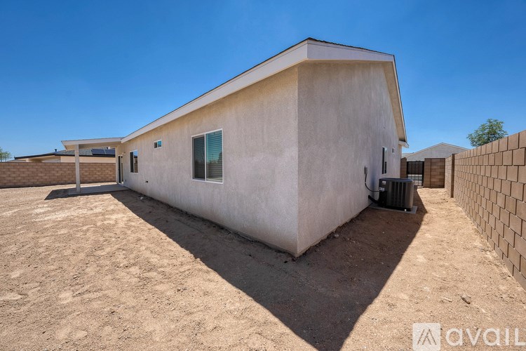 A house with a flat roof and a wall made of bricks.