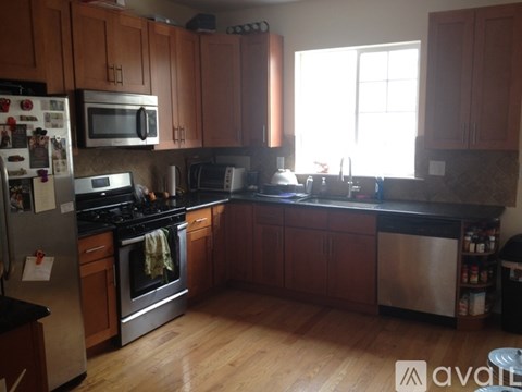 A kitchen with wooden cabinets and a black countertop.