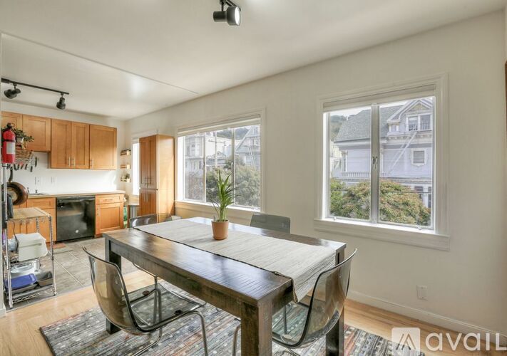 A dining room with a wooden table and chairs.