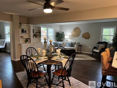 A dining room with a table set for a meal.