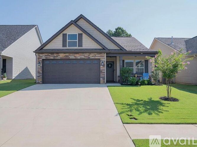 A house with a garage and a driveway in front.