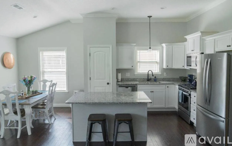 A kitchen with white cabinets and a central island.