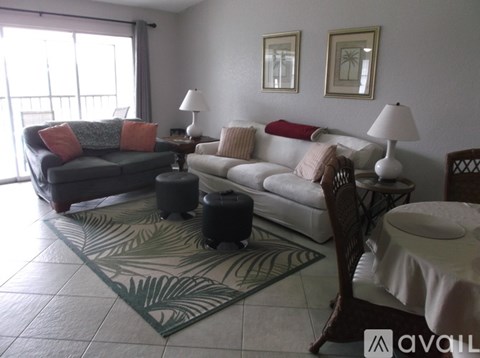 A living room with a couch, chair, and a rug.